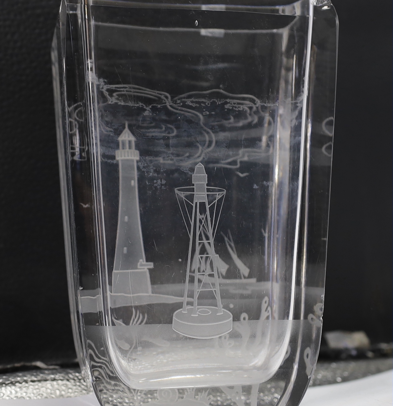 A rectangular glass vase engraved with a scene of a lighthouse and seascapes, engraved dedication base, George Saul from Aga-Graham AH, 21cm